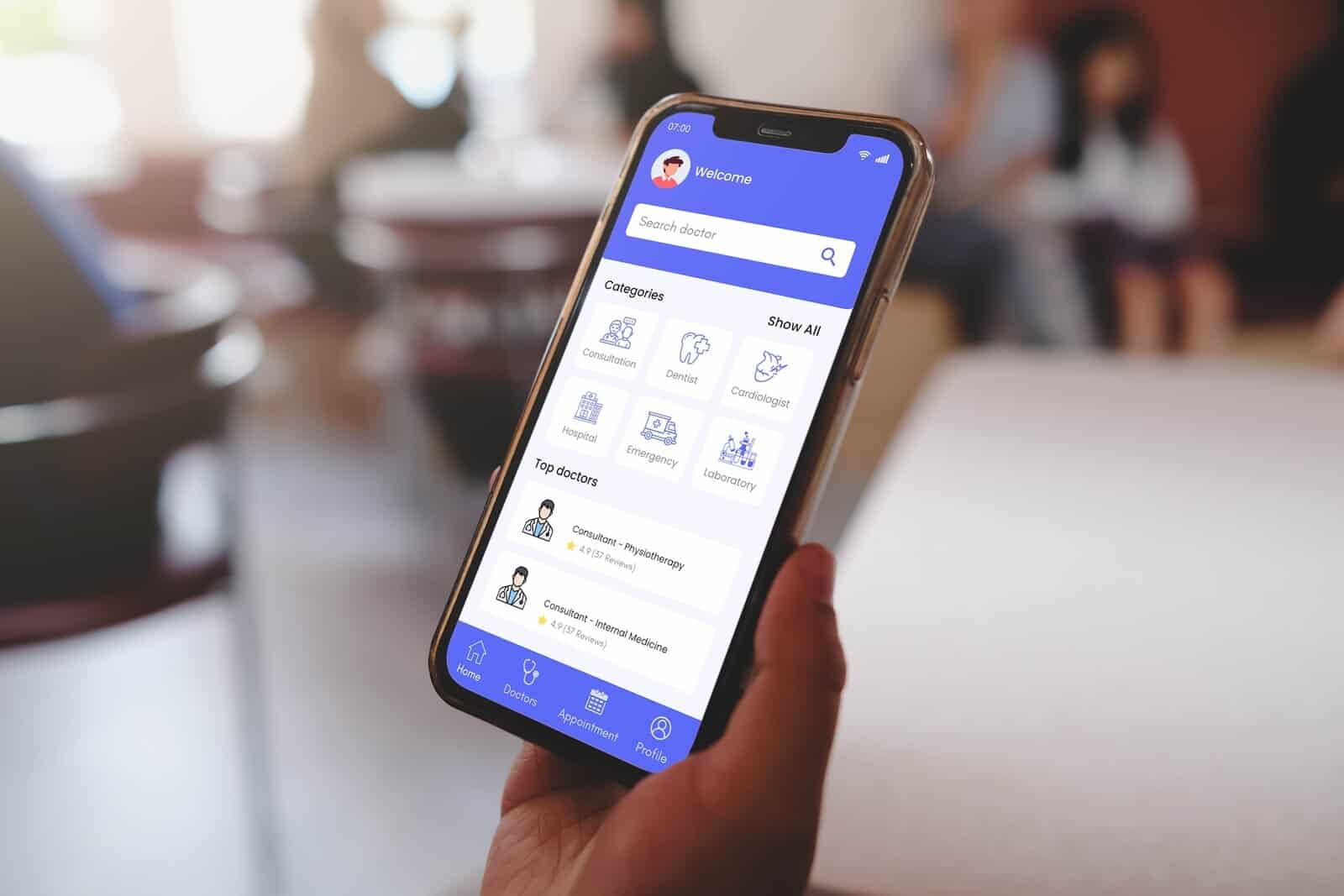 Patient holding a smartphone in hand, displaying a medical app interface for appointment scheduling